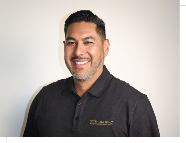 A man in black shirt smiling for the camera.